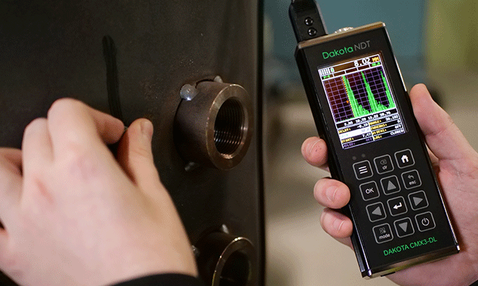 Dakota CMX3-DL Ultrasonic Corrosion Thickness Gauge measuring on Calibration Block